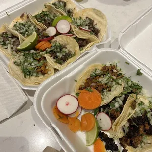 two tacoss in a styrofoam container