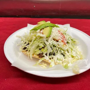 a white plate with a salad on it