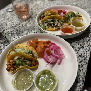 two plates of tacos on a table