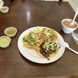 Asada and chicken street tacos with salsa and beans