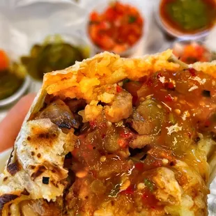 a hand holding a burrito