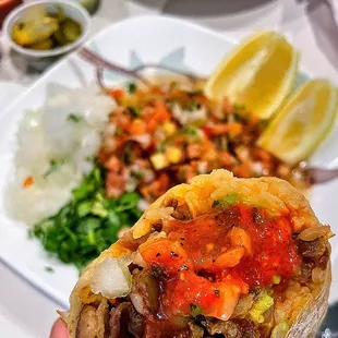 a hand holding a burrito