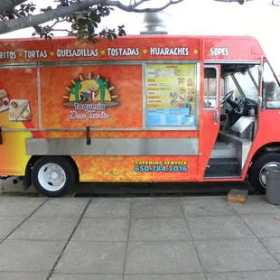 a food truck parked on a sidewalk