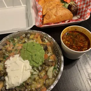 Asada fries (front) and birria tacos (back)