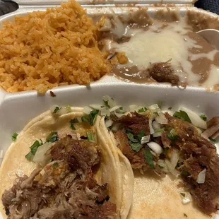 2 carnitas tacos with a side of rice &amp; beans. worth the $10 3