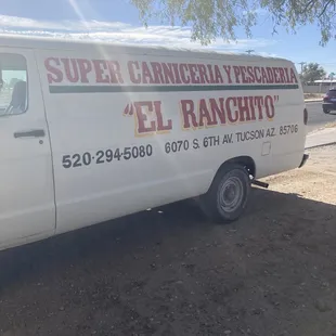 a white truck parked in a dirt lot