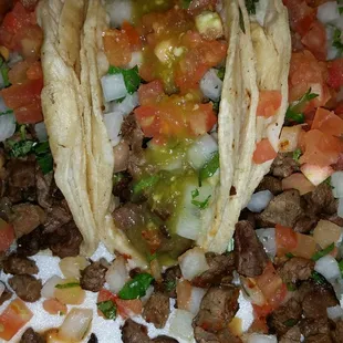 Tacos De Asada Simple ingredients But very Tasty steak cilantro onions tomatoes.