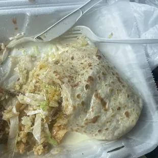 Steak burrito missing guacamole, beans, Pico de gallo sour cream and steak.