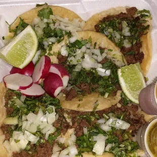 Mexican style steak tacos with cilantro,  onion, and limes.