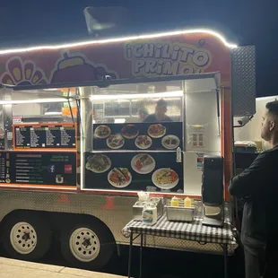 a man standing in front of a food truck