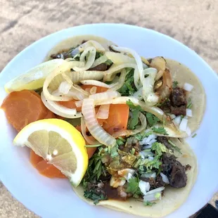 Tripas and cabeza tacos with grilled onions and pickled carrots. The best!!