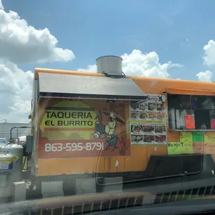 a taqueria truck on the side of the road