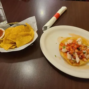 Complimentary chips and salsa and tostada ceviche