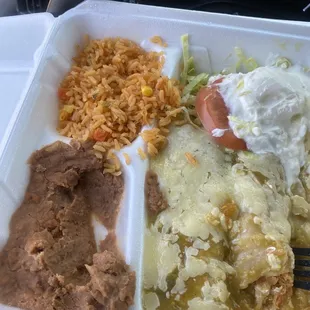 To go (3) green Chile enchiladas! It came with a tea, rice, beans, salad, tortillas a tomato, and sour cream. $ 6.49 including tax!