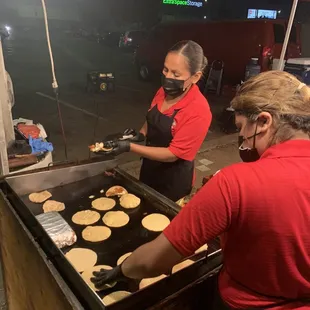 Hand made corn tortillas. Ladies making mulita and taco tortillas