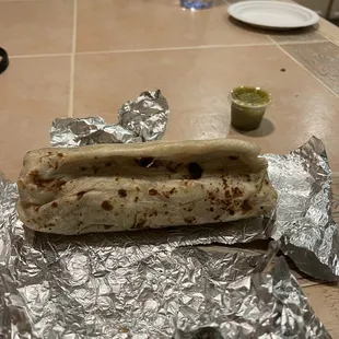 Poorly rolled burrito that is actually the size of a Taco Bell burrito if rolled correctly