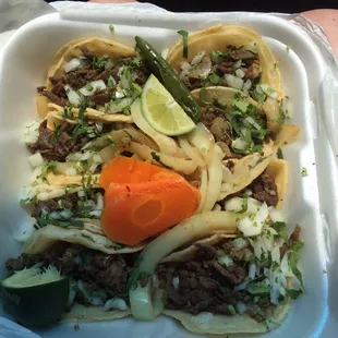 8 beef tacos in a regular to-go box.  Really delicious.