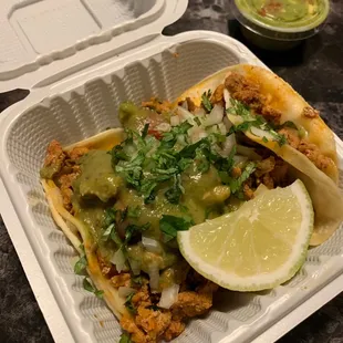 a taco with a lime wedge