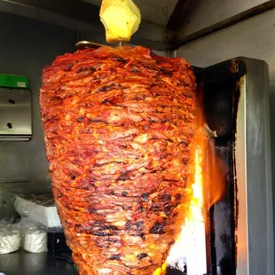 "El Trompo" (fire griller)cooks the Al-Pastor to perfection