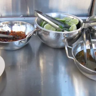 the bowls of condiments