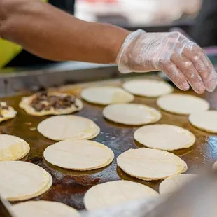 a person making tortillas