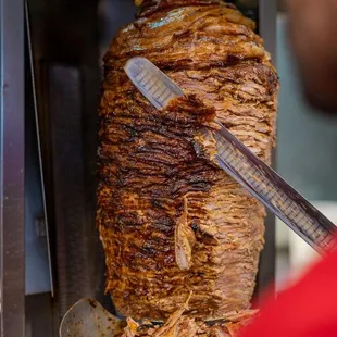 a man cutting a meat