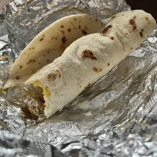 two burritos wrapped in foil