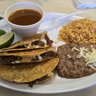 Birria with great refried beans and rice.