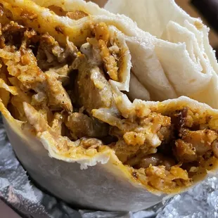 Inside the chicken burrito (w/o onions &amp; salsa). Chicken is steam-tray marinade and beans are whole beans, not refried.