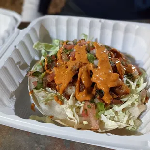 a taco in a styrofoam container