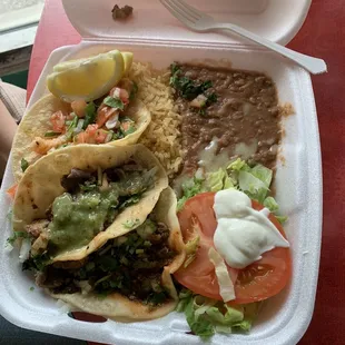 Carne asada tacos, shrimp taco, beans, and rice