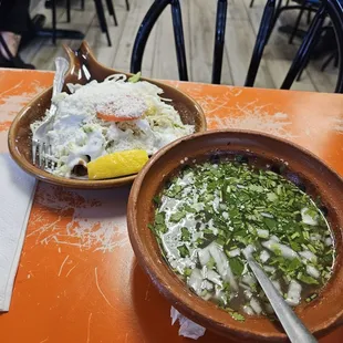 5 rolled tacos (taquitos or flautas)covered with lettuce, cojita cheese, sour cream.  In the bowl is consume (broth).