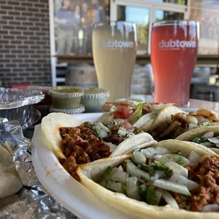 a plate of tacos and a drink