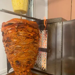 a large kebab being cooked