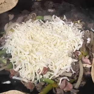 a close up of a skillet with tortillas and cheese
