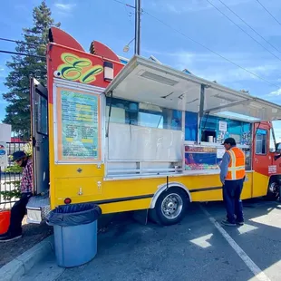 a man standing in front of a food truck
