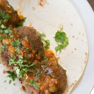two meatballs on a tortilla