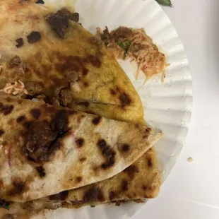 three quesadillas on a paper plate