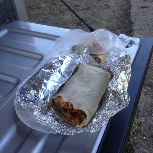 Pork burrito (half eaten) and asada burrito