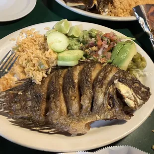 a plate of fish and rice
