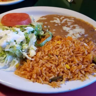 Mexican Rice, Mixed Salad and Refried Beans that accompany many dish offerings on the menu.