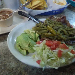 Tbone steak with nopales on top sliced avocados and lettuce tomatoes with a side of charro beans!!  Mmmmm.....this plate was delicious!!!