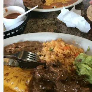 One chicken enchilada and two beef enchiladas with rice and refried beans, Side of tomatoes. Very filling ,tasty!! Delicious!!