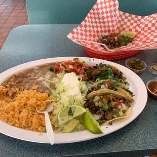 Taco plate .... Rice and beans ..... green sauce is fire tho...