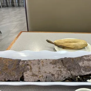 Blue corn quesadilla, loaded with stretchy cheese and mushrooms. Vegetable tamale wrapped in corn husk. Got mole sauce on the side.