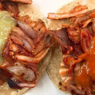 two tacos with meat and cheese
