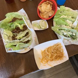 a table full of tacos and chips