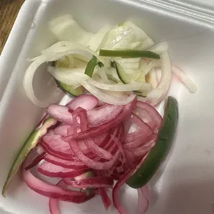 Pickled red onions and pickles white onions