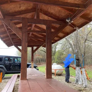 Eating area with bottle openers on the posts; hand washing station on the right.