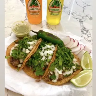 a plate of tacos and a drink